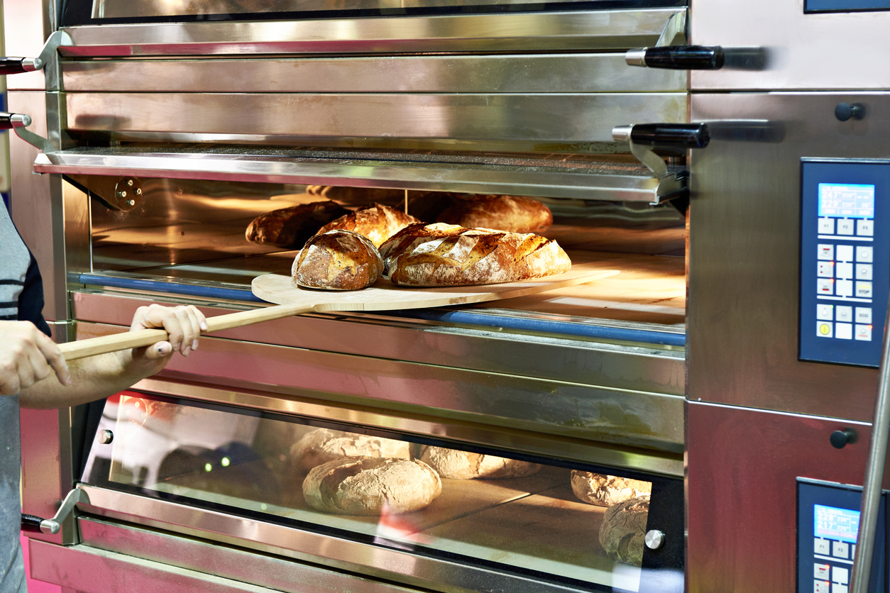 Man is baking bread in oven stock