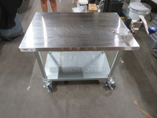 One Stainless Steel Table With Under Shelf And 10lb Edlund Can Opener, On Casters. 36X24X28 - Image 1 of 5