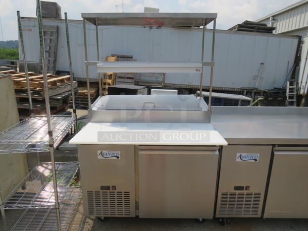 One Stainless Steel Avantco 1 Door Refrigerated Prep Table With 2 SS Over Shelves, 1 Rack, 36 Inch Ticket Rail, And  Cutting Board On Casters. Model# 178SSPPT-1. 115 Volt. 44.5X37X73.  - Image 1 of 4