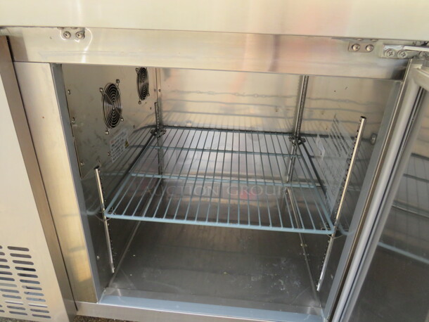 One Stainless Steel Avantco 1 Door Refrigerated Prep Table With 2 SS Over Shelves, 1 Rack, 36 Inch Ticket Rail, And  Cutting Board On Casters. Model# 178SSPPT-1. 115 Volt. 44.5X37X73.  - Image 3 of 4