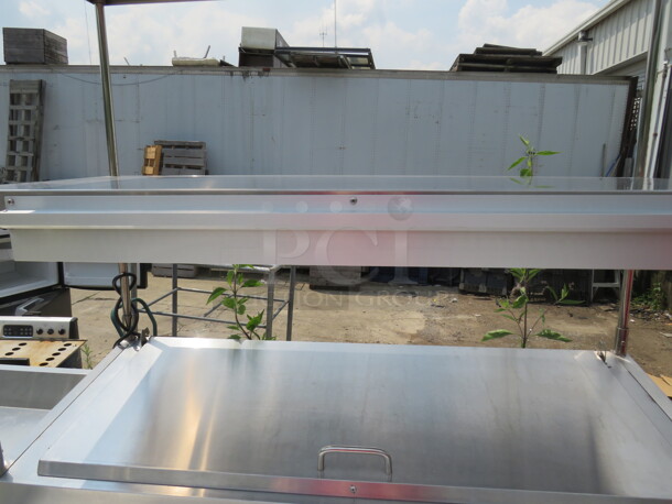 One Stainless Steel Avantco 1 Door Refrigerated Prep Table With 2 SS Over Shelves, 1 Rack, 36 Inch Ticket Rail, And  Cutting Board On Casters. Model# 178SSPPT-1. 115 Volt. 44.5X37X73.  - Image 4 of 6