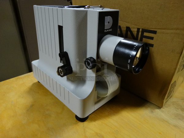 BRAND NEW IN BOX! Dukane Model 28A55A Metal Countertop Filmstrip Slide Projector. 120 Volts, 1 Phase. 6x10x9. (Downstairs Art Storage Room)