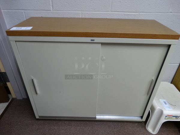 Metal Tan 2 Door Cabinet w/ Wood Pattern Countertop. 35x13x30. (Main School Office)