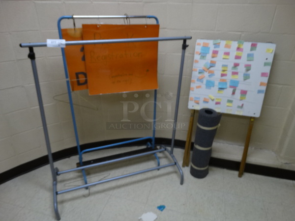 4 Various Items; Coat Rack, Sign Stand, Easel and Roll of Carpet. Includes 44x20x48. 4 Times Your Bid! (Storage Room Off Of Main Entrance)