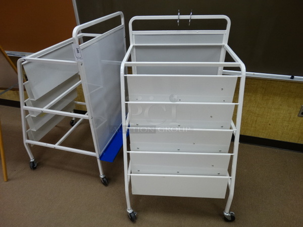 2 White Metal Portable Magazine Racks on Commercial Casters. 28x33x49. 2 Times Your Bid! (Downstairs Room 9)