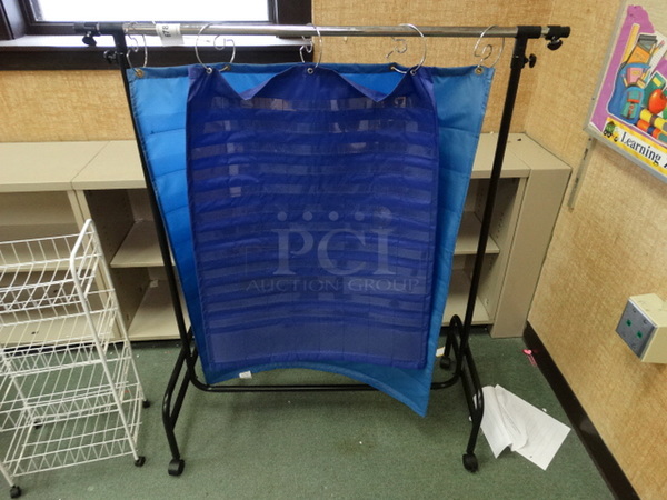Metal Frame w/ Blue Hanging Material on Casters. 37x20x50. (Room 207)
