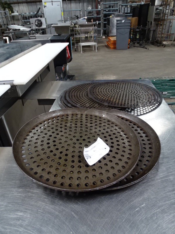 7 Times Your Bid. 7 Round, Perforated Baking Pans In Miscellaneous Sizes.