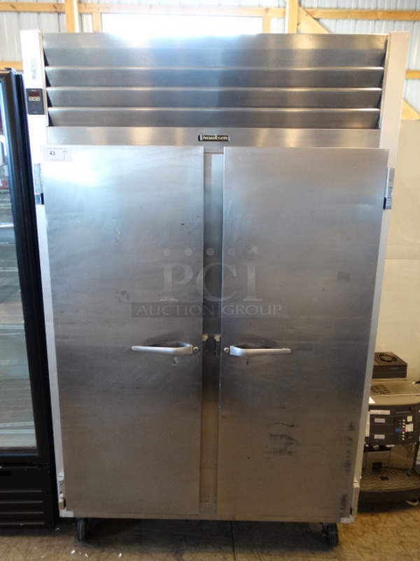 AWESOME! Traulsen Model G22010 Stainless Steel Commercial 2 Door Reach In Freezer on Commercial Casters. 115 Volts, 1 Phase. 52x34x83. Tested and Working!