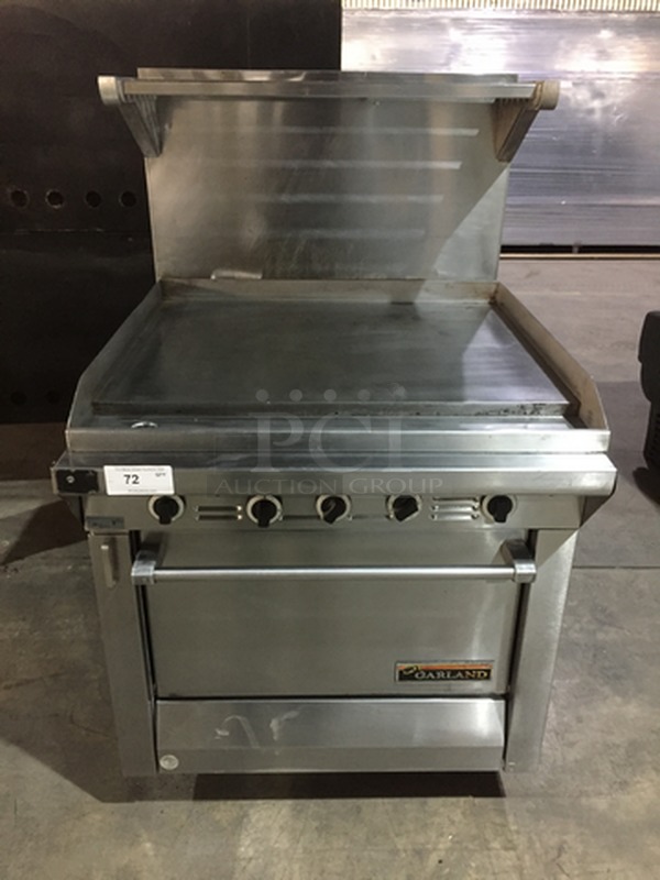 BEAUTIFUL! Garland Commercial Natural Gas Powered Flat Griddle/Plancha! With Raised Backsplash & Salamander Shelf! With Full Size Oven Underneath! All Stainless Steel! Model M47R Serial 0611100156009! On Legs!