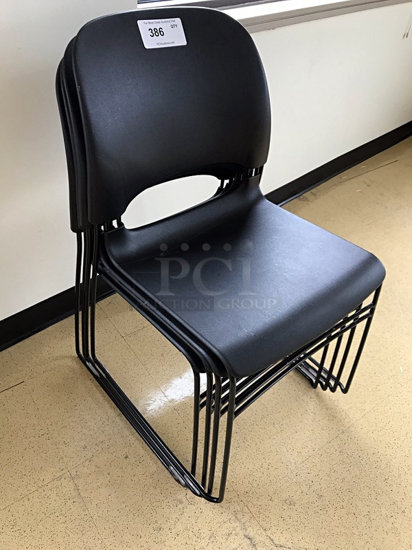 Four Black Plastic Stackable Chairs