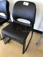 Four Black Plastic Stackable Chairs