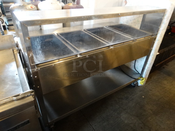 NICE! Vollrath Model 38004 Stainless Steel Commercial Electric Powered 4 Well Steam Table w/ Sneeze Guard and Metal Undershelf on Commercial Casters. 120 Volts, 1 Phase. 61x32x48. Tested and Working!