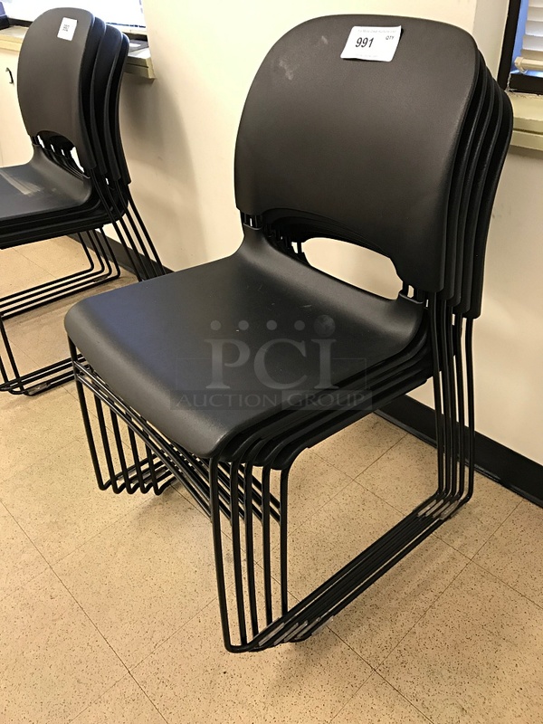 Five Stackable Black Plastic Task Chairs