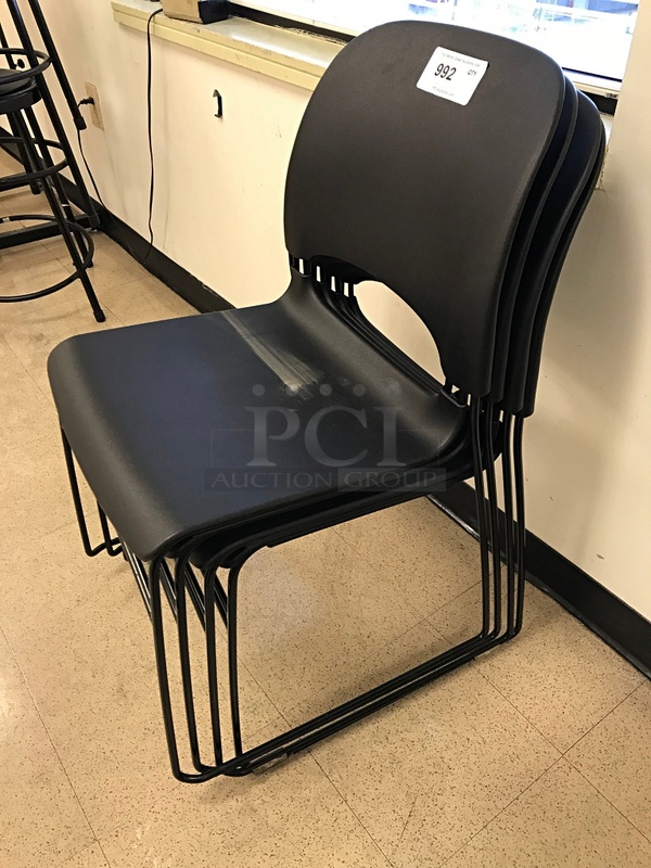 Four Stackable Black Plastic Task Chairs