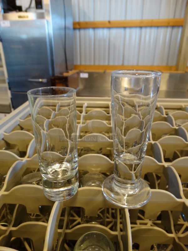 26 Beverage Glasses; Tall Shot And Footed in Dish Caddy. 1.5x1.5x4, 2x2x4.5. 26 Times Your Bid! - Image 1 of 4