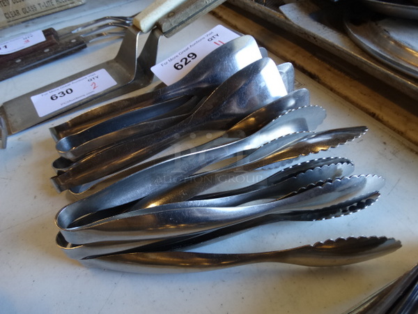 11 Metal Tongs. 9