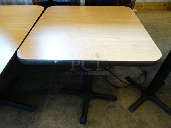 Light Wood Pattern Tabletop w/ Dark Wood Pattern Underside on Black Metal Table Base. Stock Picture - Cosmetic Condition May Vary. 24x24x30