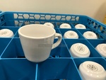 Two Dish Racks of White Porcelain Coffee Cups