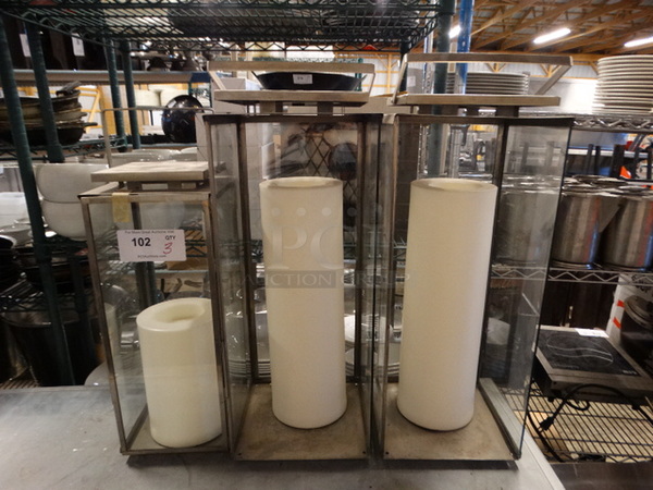 3 Fake Candles in Glass Cases. The 2 Taller Cases Are Missing 1 Panel Each. Includes 10x10x25. 3 Times Your Bid!