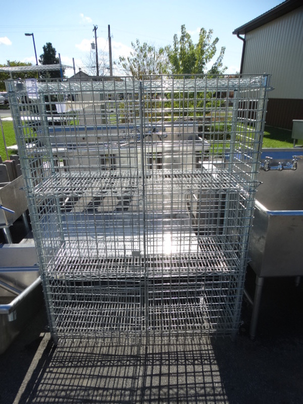 Chrome Finish 4 Tier Shelving Unit w/ Liquor Cage. 48x19x63. BUYER MUST DISMANTLE. PCI CANNOT  DISMANTLE FOR SHIPPING. PLEASE CONSIDER FREIGHT CHARGES. 