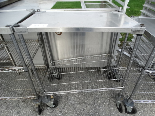 Chrome Finish 2 Tier Metro Shelving Unit on Commercial Casters. 30x18x35. BUYER MUST DISMANTLE. PCI CANNOT  DISMANTLE FOR SHIPPING. PLEASE CONSIDER FREIGHT CHARGES.  - Image 1 of 5