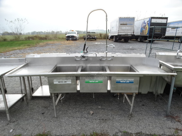 Stainless Steel Commercial 3 Bay Sink w/ Left Side Drainboard, Faucets, Handles and Spray Nozzle Attachment. 105x30x43. Bays 1824x12. Drainboard 22x27x2
