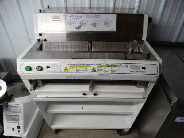 FANTASTIC! Oliver Model 758N Metal Commercial Floor Style Front Load Bread Loaf Slicer w/ 2 Thickness Options on Commercial Casters. 115 Volts, 1 Phase. 34x29x50. Tested and Working!