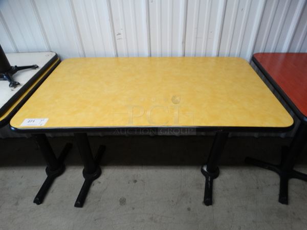 Yellow Table on 2 Black Metal Straight Leg Table Bases. Stock Picture - Cosmetic Condition May Vary. 48x30x30