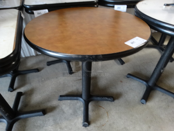 Round Brown Table on Black Metal Table Base. Stock Picture - Cosmetic Condition May Vary. 28x28x30