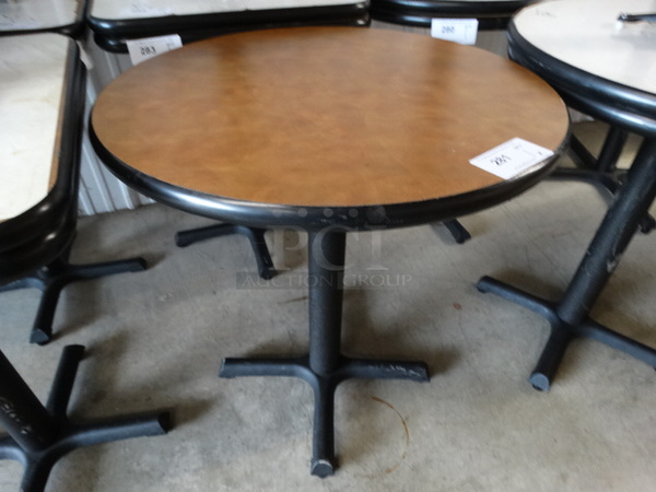 Round Brown Table on Black Metal Table Base. Stock Picture - Cosmetic Condition May Vary. 28x28x30 - Image 1 of 4