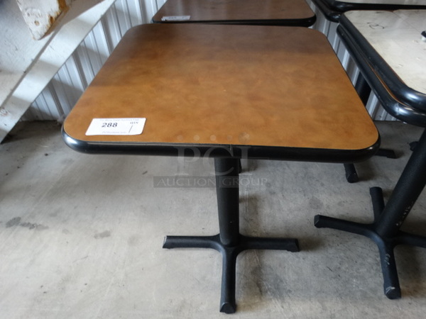 Brown Table on Black Metal Table Base. Stock Picture - Cosmetic Condition May Vary. 24x24x30