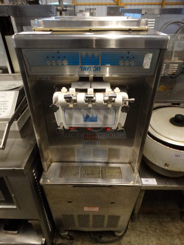 SWEET! Taylor Model 336-27 Stainless Steel Commercial Air Cooled Floor Style 2 Flavor w/ Twist Soft Serve Ice Cream Machine on Commercial Casters. 208-230 Volts, 1 Phase. 20x34x60