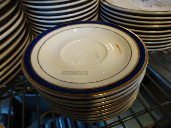 10 White Ceramic Saucers w/ Blue and Gold Colored Lines on Rim. 5.75x5.75x1. 10 Times Your Bid!