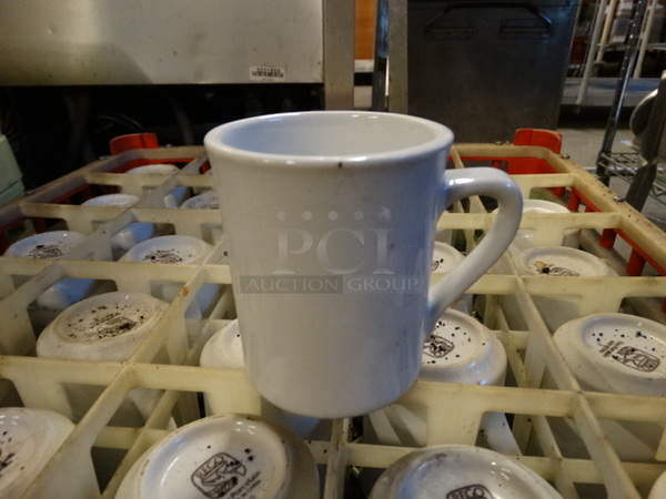 24 White Ceramic Mugs in Dish Caddy. Includes 4.5x3x4. 24 Times Your Bid!