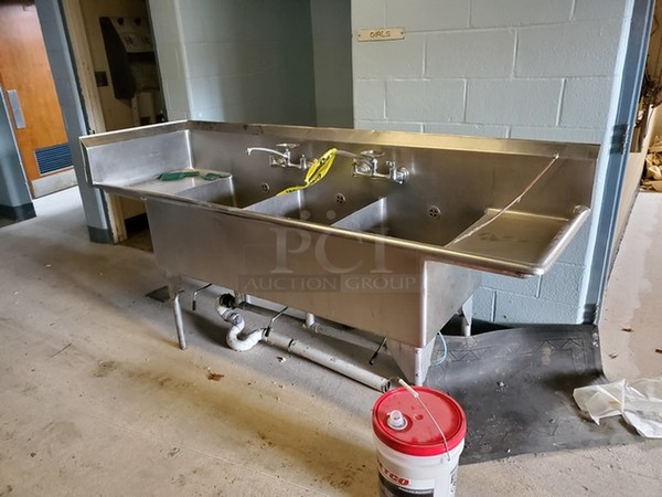 Stainless Steel Commercial 3 Bay Sink w/ Dual Drainboards, 2 Faucets and Handles.  - Image 1 of 1