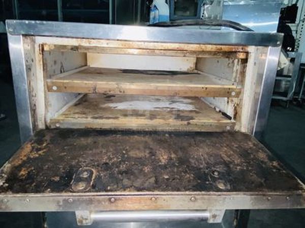 Bakers Pride P-44S Electric Countertop Pizza and Pretzel Oven On Commercial Casters - 208V, 1 Phase, 7200W   26”W x 28 1/2”H x 28”D   Baking Chamber Width 20 3/4 Inches Baking Chamber Depth 20 3/4 Inches Deck Height 3 1/4 Inches  Exterior Material: Stainless Steel Interior Material: Aluminized Steel Number of Decks: 4 Number of Doors: 2 Power Type: Electric Style: Deck Style Temperature Range: 300 - 650 Degrees F - Image 4 of 8