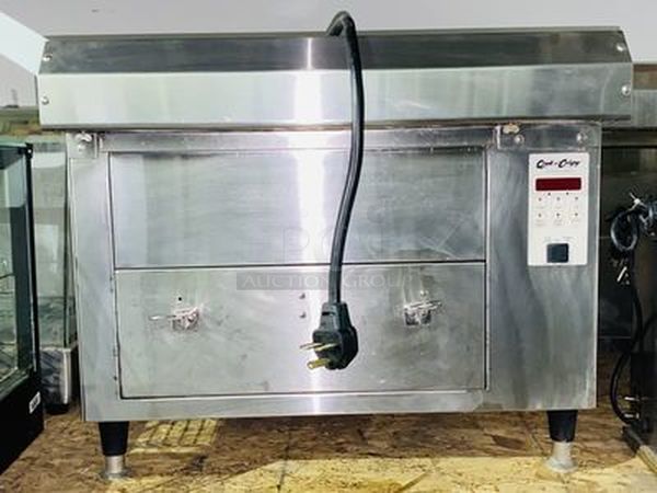 AMAZING! Quik N' Crispy GF5 Greaseless Fryer. Works Like New!   The patented Quik n’ Crispy® Model GF5 uses a combination of forced hot air, radiant heat, and an elevated perforated cooking basket to prepare ovenable frozen foods to the taste and texture as if they were deep-fat fried.   Dimensions: 23-1/2" W x 20" D x 13-1/2" H 208V (29 amp) / 60Hz/ 1 Phase Plug Type: NEMA #6-30R Weight: 175 lbs  Can Stack multiple to save space and increase productivity. Works Like New. - Image 1 of 10