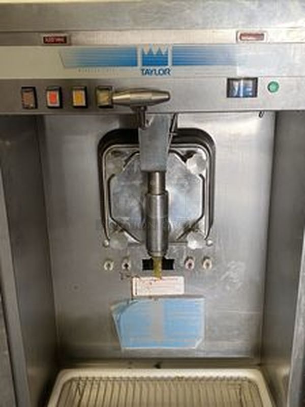 Taylor Model 60-27 Air Cooled Shake Freezer With Four Flavor Options. 208-230V/60Hz/1Ph Air Cooled - 18-7/16x32x59-7/8  Features  Offer four separate shake flavors: chocolate, strawberry, vanilla (unflavored shake mix) and an optional flavor.  Freezing Cylinder: One, 7 quart (6.6 liter).  Mix Hopper: One, 20 quart (18.9 liter). Separate hopper refrigeration (SHR) maintains mix below 41oF (5oC).  Indicator Lights: Add Mix light alerts the operator to add mix. When the Mix Out light flashes, the unit automatically shuts down to prevent damage.  Accurate Consistency Control: Torque control precisely maintains superior shake quality in texture, viscosity and taste.  Shake Syrup System: Shake flavors are selected from push buttons. Self-contained air compressor delivers shake syrup from three, 1 gallon (3.8 liter) syrup tanks located in the lower front compartment.  Automatic Dispensing: Press the desired flavor button, and either raise the draw handle or use the foot pedal for hands free d - Image 2 of 10