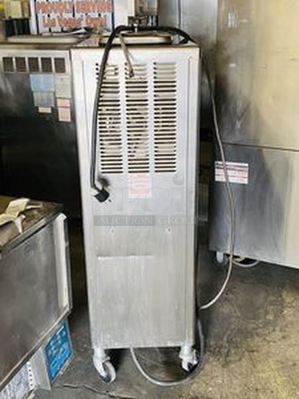 Taylor Model 60-27 Air Cooled Shake Freezer With Four Flavor Options. 208-230V/60Hz/1Ph Air Cooled - 18-7/16x32x59-7/8  Features  Offer four separate shake flavors: chocolate, strawberry, vanilla (unflavored shake mix) and an optional flavor.  Freezing Cylinder: One, 7 quart (6.6 liter).  Mix Hopper: One, 20 quart (18.9 liter). Separate hopper refrigeration (SHR) maintains mix below 41oF (5oC).  Indicator Lights: Add Mix light alerts the operator to add mix. When the Mix Out light flashes, the unit automatically shuts down to prevent damage.  Accurate Consistency Control: Torque control precisely maintains superior shake quality in texture, viscosity and taste.  Shake Syrup System: Shake flavors are selected from push buttons. Self-contained air compressor delivers shake syrup from three, 1 gallon (3.8 liter) syrup tanks located in the lower front compartment.  Automatic Dispensing: Press the desired flavor button, and either raise the draw handle or use the foot pedal for hands free d - Image 5 of 10