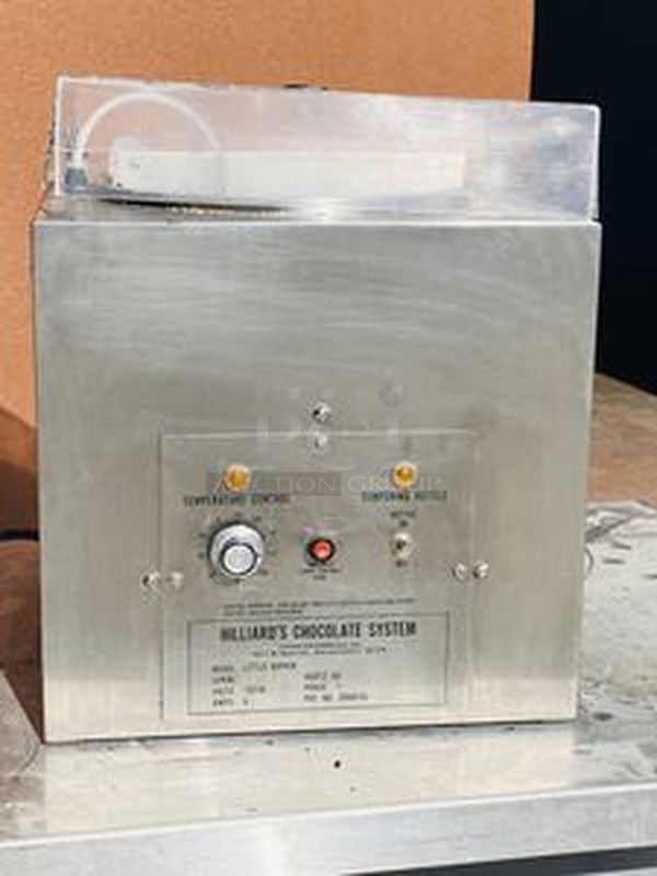 Hilliard Chocolate System Model: Little Dipper
Automatic Chocolate Melting and Tempering Machine. 

Capacity: 25 lbs. (12 kg.) per day 

Size: 16" x 16" x 17" (41 x 41 x 43 cm) 

Tested. Working. 

Electrical Requirements: 120 volts, 400 watts. Units can be supplied to meet other electrical requirements. - Image 3 of 6