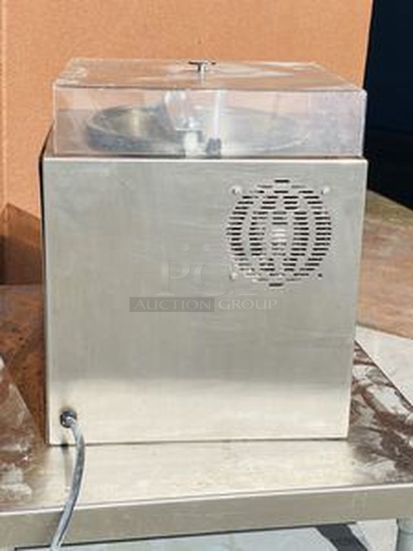 Hilliard Chocolate System Model: Little Dipper
Automatic Chocolate Melting and Tempering Machine. 

Capacity: 25 lbs. (12 kg.) per day 

Size: 16" x 16" x 17" (41 x 41 x 43 cm) 

Tested. Working. 

Electrical Requirements: 120 volts, 400 watts. Units can be supplied to meet other electrical requirements. - Image 4 of 6