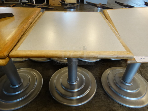 2 Gray Tables w/ Wood Pattern Rim on Metal Table Base. Stock Picture - Cosmetic Condition May Vary. 24x30x29. 2 Times Your Bid!