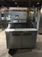 Atosa Commercial Refrigerated Sandwich Prep Table! With 2 Door Underneath Storage Space! With Poly Coated Racks! With Commercial Cutting Board! With Overhead Serving Shelf! All Stainless Steel! Model MSF8302GR Serial MSF8302GRAUS100317042600C40036! 115V 1Phase! On Commercial Casters!