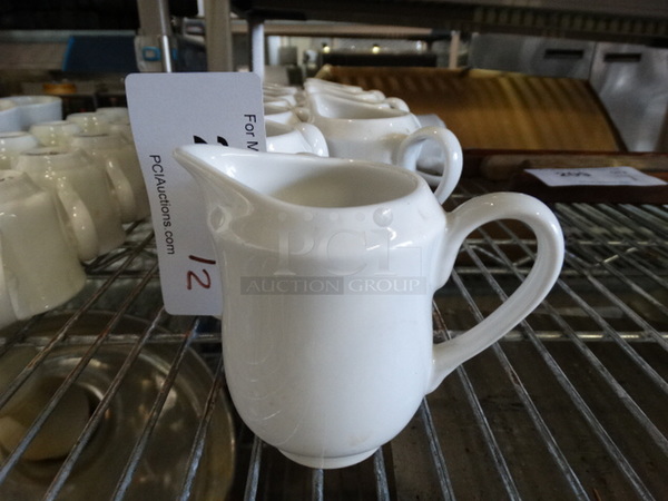 12 White Ceramic Pitchers. 4.5x3x4. 12 Times Your Bid!