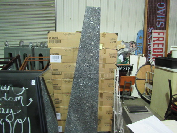 One 78 Inch Long Triangular Slab Of Granite With Metal On Back.