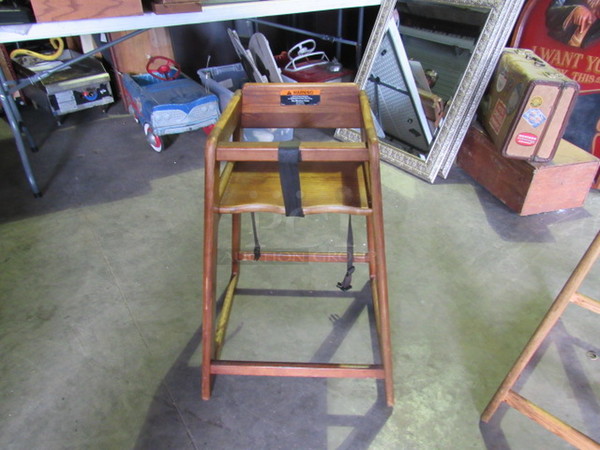 One Wooden High Chair With Safety Straps.