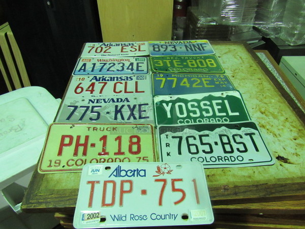One Lot Of 11 Assorted License Plates.