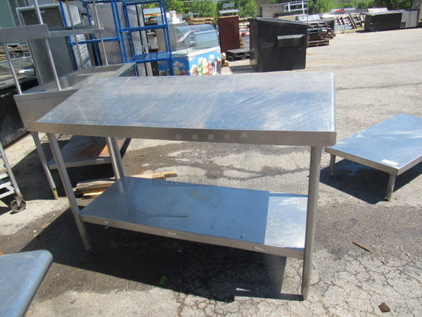 One Stainless Steel Table With Slanted Top And Stainless Under Shelf.