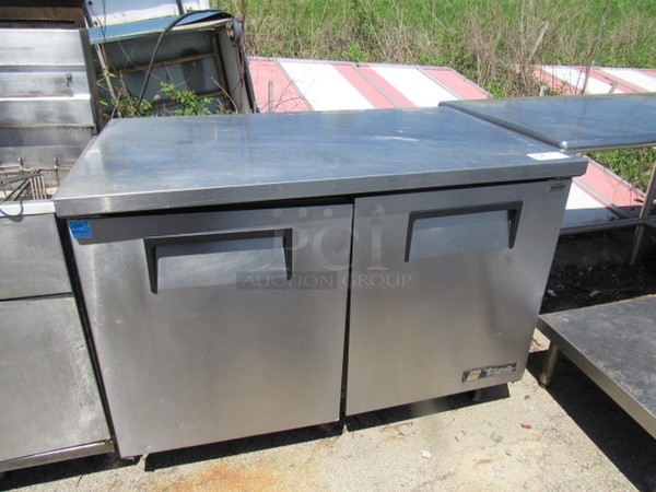 One SS True 2 Door Work Top Refrigerator With 2 Racks On Commercial Casters. 115 Volt. Model# TUC-48. 48X30X36