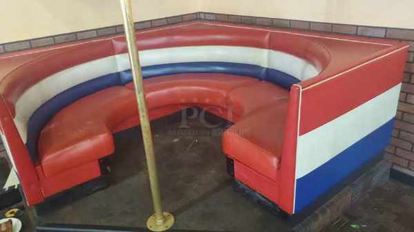 One Beautiful Corner Booth With Cushioned Seat And Back.